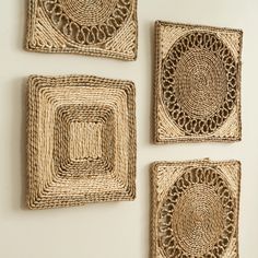 three square woven coasters on a wall