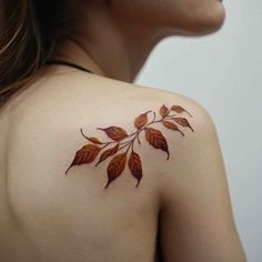 a woman's shoulder with leaves on it