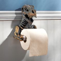 a toy t - rex holding a roll of toilet paper