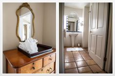 a bathroom with a sink, mirror and toilet paper on top of a wooden dresser