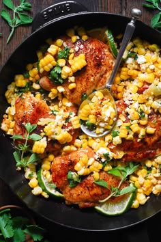 a skillet filled with chicken, corn and cilantro