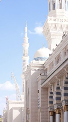 a large white building with a clock on it's side