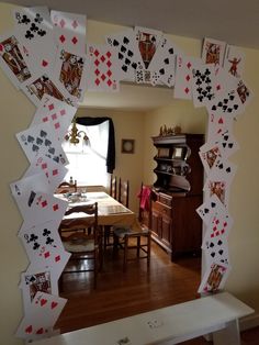 an arch made out of playing cards in the dining room