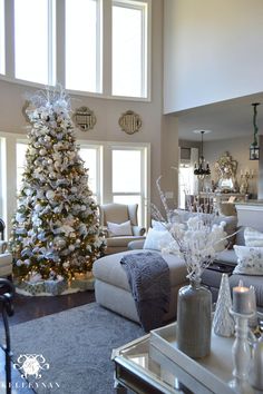 a living room filled with furniture and a christmas tree in the middle of the room