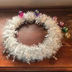 a christmas wreath with silver tinsel and ornaments