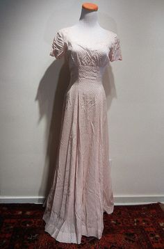 "The quintessential 1930 tea dress. Scalloped bust line and sleeves, fitted bodice, zip back, gorgeous framing of decollette, and a six gore bias cut flare to the skirt. Minor discoloration at edge of neckline in back. And how about those matching gloves that finish the look?! My mannequin has a 36 bust and 24\" waist. Length is 56\" from center neckline / collar to hem. It is fitting my mannequin as though it were made for her. The rib cage tapers to 26 under bust and to the waist to create the Fitted Bias Cut Dress With Short Sleeves, Fitted Bias Cut Dresses With Short Sleeves, Classic Fitted Vintage Dress For Vintage Events, Fitted Full Length Bias Cut Dress, Classic Fitted Full-length Dress, Fitted Polka Dot Vintage Dress, 1950s Fitted Dresses For Vintage Events, Vintage Event Dresses With Fitted Bodice And Short Sleeves, Fitted Vintage Dress With Square Neck For Evening