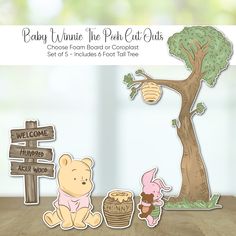 a winnie the pooh cut out is sitting in front of a tree and some other items