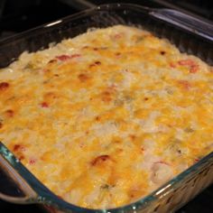 a casserole dish with cheese and meat in it sitting on the stove top