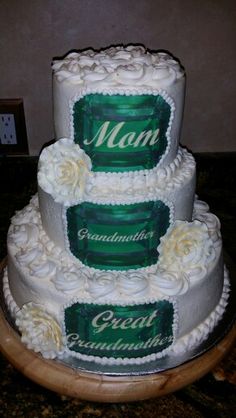 three tiered cake with white frosting and green labels