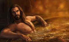 a man with long hair sitting in the water