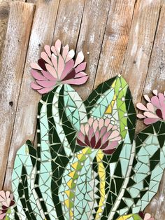 a mosaic cactus with pink and green flowers