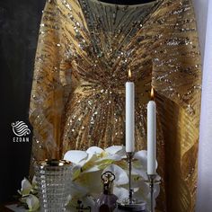 a table topped with candles next to a vase filled with flowers