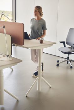 a woman sitting at a desk with a laptop