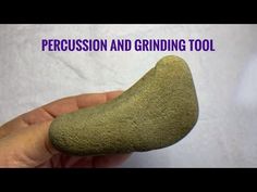 a person holding a rock with the words percussion and grinding tool