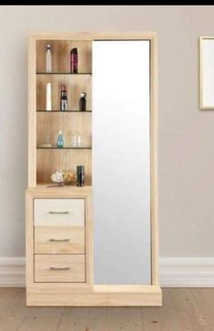 a tall wooden cabinet with drawers and a mirror