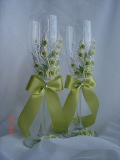 two wine glasses decorated with flowers and ribbons