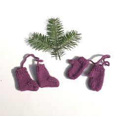 three knitted mittens and one pine tree