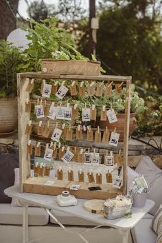 a table topped with lots of cards next to potted plants and hanging from strings