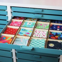 a drawer filled with lots of different colored papers