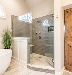 a bathroom with a tub, sink and shower in it