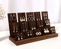 a wooden display with earrings on it