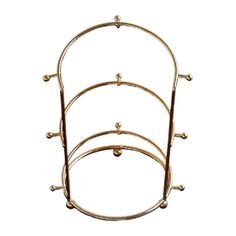 three tiered gold metal rack with balls on the top and two shelves below it