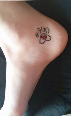 a person with a tattoo on their foot that reads 100 and has a heart in it