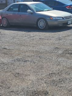 a car parked in a parking lot next to other cars