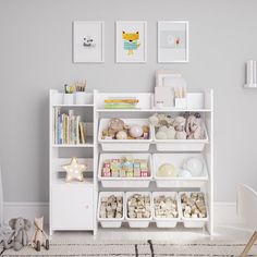 a white book shelf filled with lots of books next to a baby's room