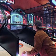 a man is playing bowling in a pinball game