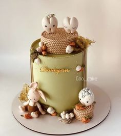 a green cake decorated with bunnies and rabbits