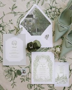 the wedding stationery is laid out on the bed