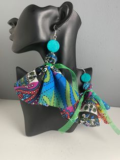 Dangle earrings are made from turquoise, blue, green, and purple print fabric.  Turquoise print fabric dangle earrings, cloth dangle earrings, cloth earrings. Cloth Earrings, Earrings Fabric, Turquoise Print, Fabric Earrings, Fabric Jewelry, Etsy Earrings Dangle, Print Fabric, Turquoise Blue, Jewelry Ideas