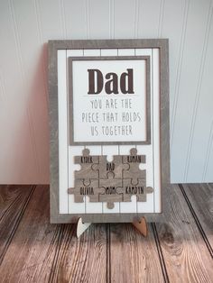 a wooden puzzle with the words dad on it