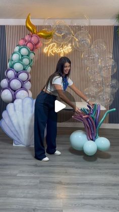 a woman standing in front of a balloon sculpture