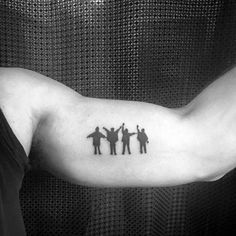 a man's arm with three silhouettes on it, and one is holding the other