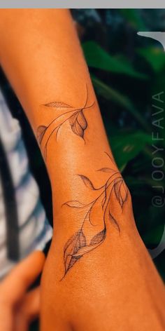 a woman's arm with a flower tattoo on it