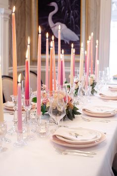 the table is set with candles and plates