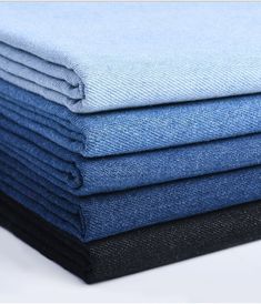 several folded blue and black cloths stacked on top of each other