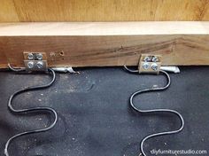 three wires are plugged into the side of a wooden box