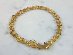 "FOR SALE IS A VINTAGE ESTATE 10K YELLOW GOLD HEART FILIGREE BRACELET. THE BRACELET MEASURES 7 1/4\" LONG FROM THE CLASP BY 1/4\" WIDE, AND WEIGHS 7.4g. CONDITION IS VERY GOOD. THIS WOULD MAKE A LOVELY GIFT AND IS A GREAT VALUE FOR THE MONEY. IF ANY OTHER QUESTIONS, PLEASE ASK. BE SURE TO CHECK OUT SOME OF MY OTHER GREAT ITEMS UP FOR SALE. THANK YOU" Gold Heart Bracelet, Filigree Bracelet, Heart Bracelet, Heart Of Gold, Chain Link Bracelet, Lovely Gift, Gold Bracelet, Yellow Gold, Yellow