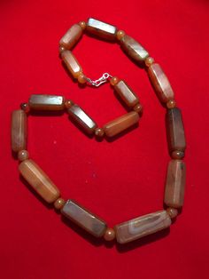 A beautiful 900 years old Pre Ankur carnelian beads necklace from Cambodia, worn by royals at that time as a luck charm. agate beads as counters. In great condition and colors of the beads are exceptional with great shine on its surface as its been continuesly used since then till now. Brown Agate Jewelry With Faceted Beads, Brown Carnelian Gemstone Beaded Necklace, Amber Agate Beaded Necklaces With Faceted Beads, Luck Charm, Carnelian Beads, Luck Charms, Angkor, Shine On, Burmese