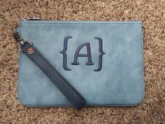 a blue leather pouch with the letter a on it