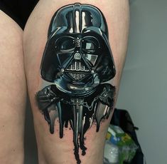 a tattoo with a darth vader mask on it's thigh and dripping paint