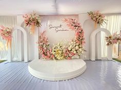 a wedding stage decorated with pink and white flowers