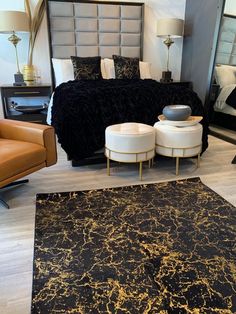 a bedroom with black and gold decor in it