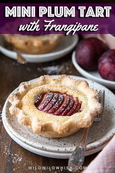 two small pies sitting on top of white plates next to cups and saucers