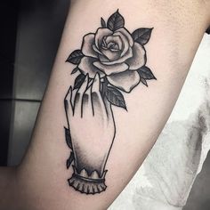 a black and white rose tattoo on the arm