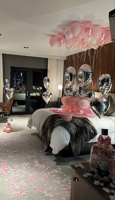 a bedroom decorated with balloons and streamers