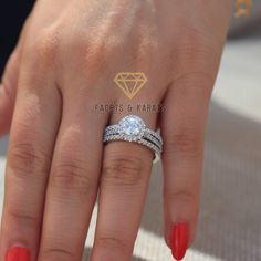 a woman's hand with two wedding rings on it and a diamond in the middle